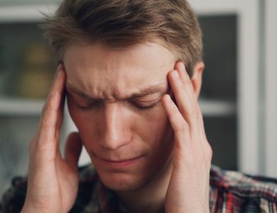 a man holding his hands to his ears