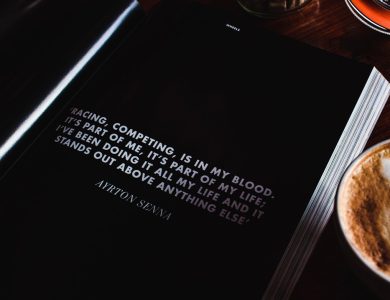 a cup of coffee and a book on a table