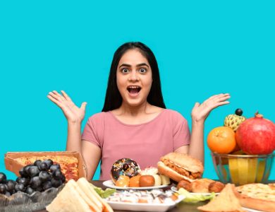 a woman with her mouth open and hands up in front of a table of food