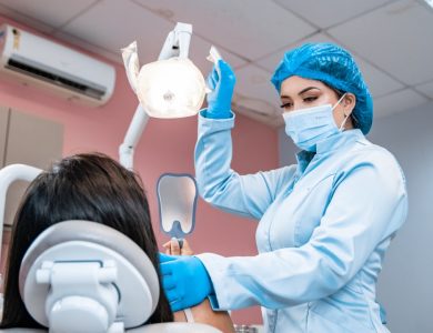 a woman getting her teeth checked by a dentist