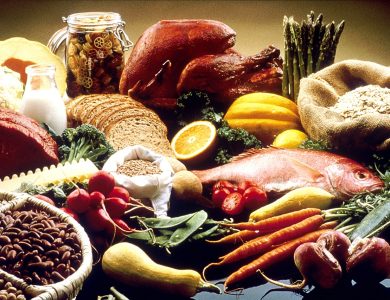 A table displaying vegetables, fruit, grains, beans, fish, meat and other foods.