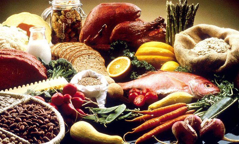 A table displaying vegetables, fruit, grains, beans, fish, meat and other foods.